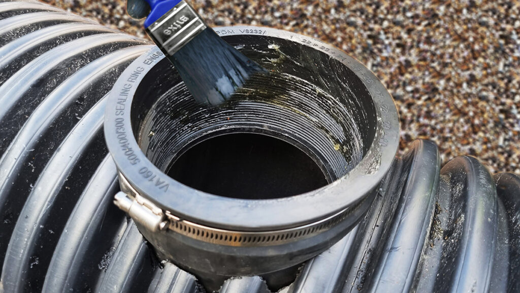VTWS Twinwall saddle installed into a twin wall pipe, lubricant being added prior to lateral pipe insertion Install 4
